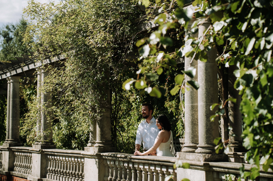 The Curated Wedding Engagement Couple Looking Over Balcony